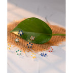 Daisy Decorative Gems Flower Beads showcased on natural fiber, highlighting high-quality finish and vibrant colors. Available at Curat Cart.