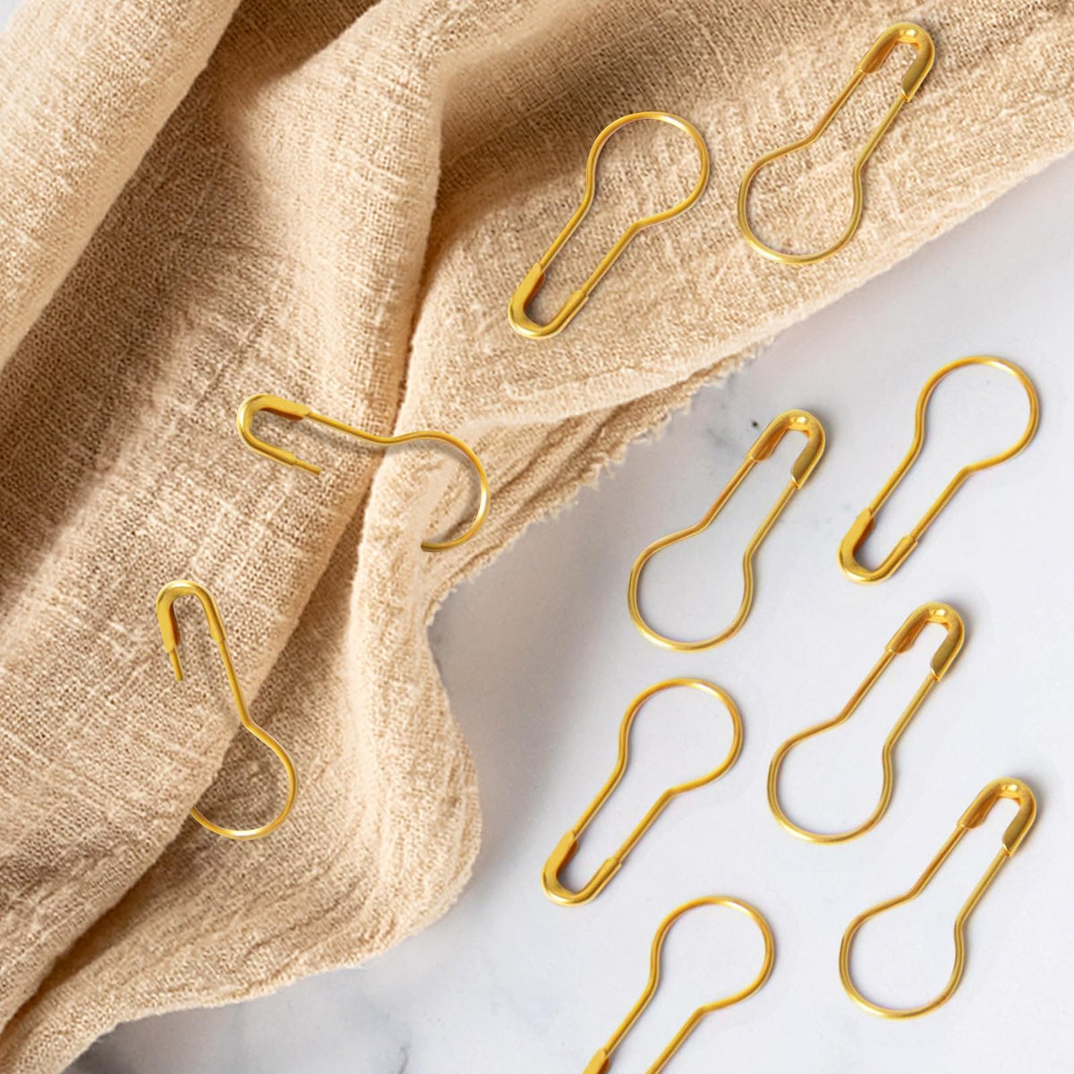 Gold safety pins for DIY craft projects, perfect for adding elegance to your creations. Available at Curat Cart.