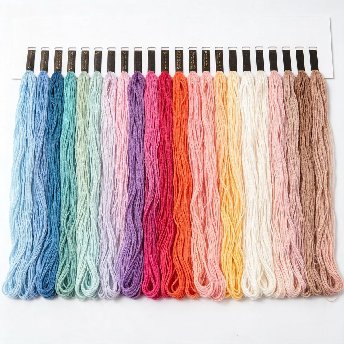 A premium assortment of rainbow color embroidery floss in official packaging from Curat Cart, showcasing high-quality threads for creative projects.