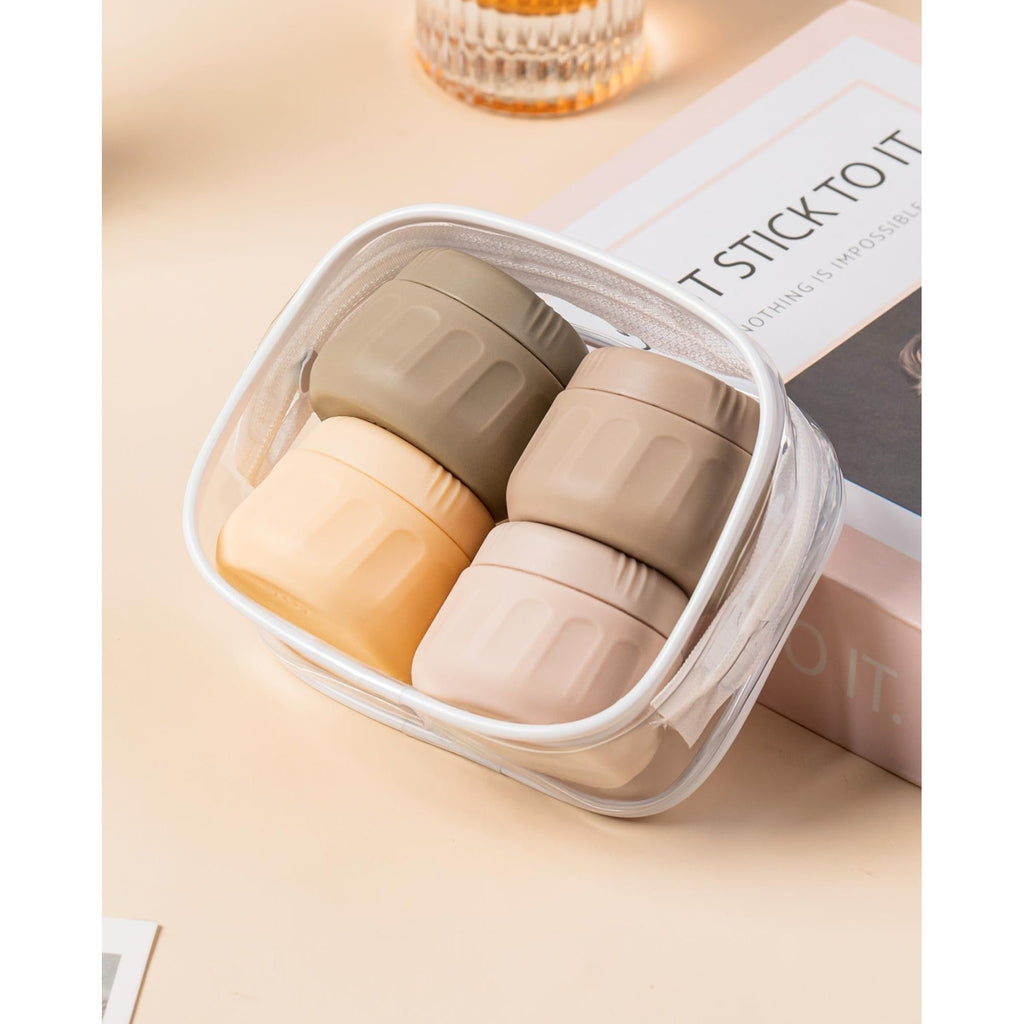 Set of four eco-friendly travel containers for toiletries in stylish colors. Order online, available now!