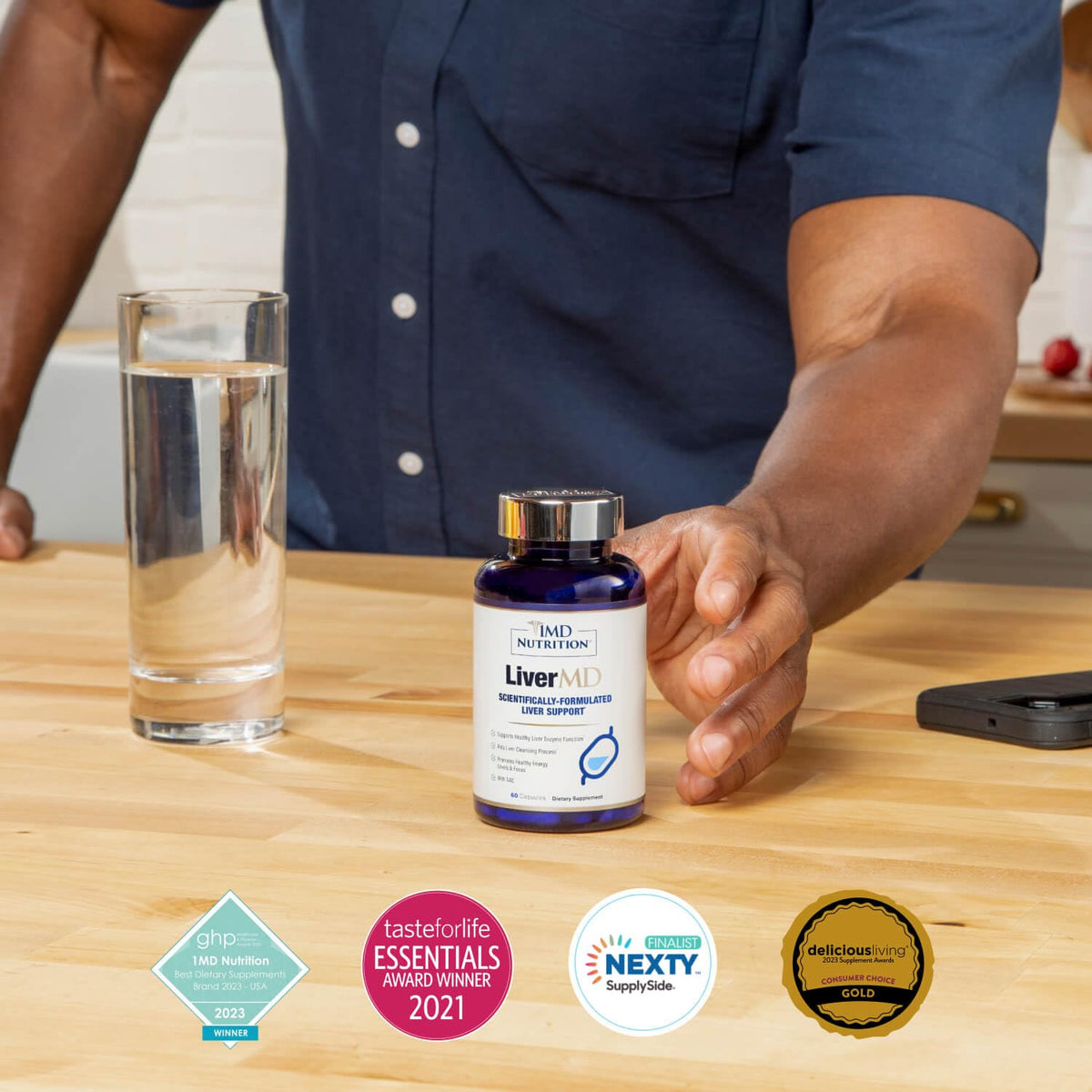 1MD Nutrition Liver Support Supplement displayed next to a glass of water, showcasing original packaging and award badges.