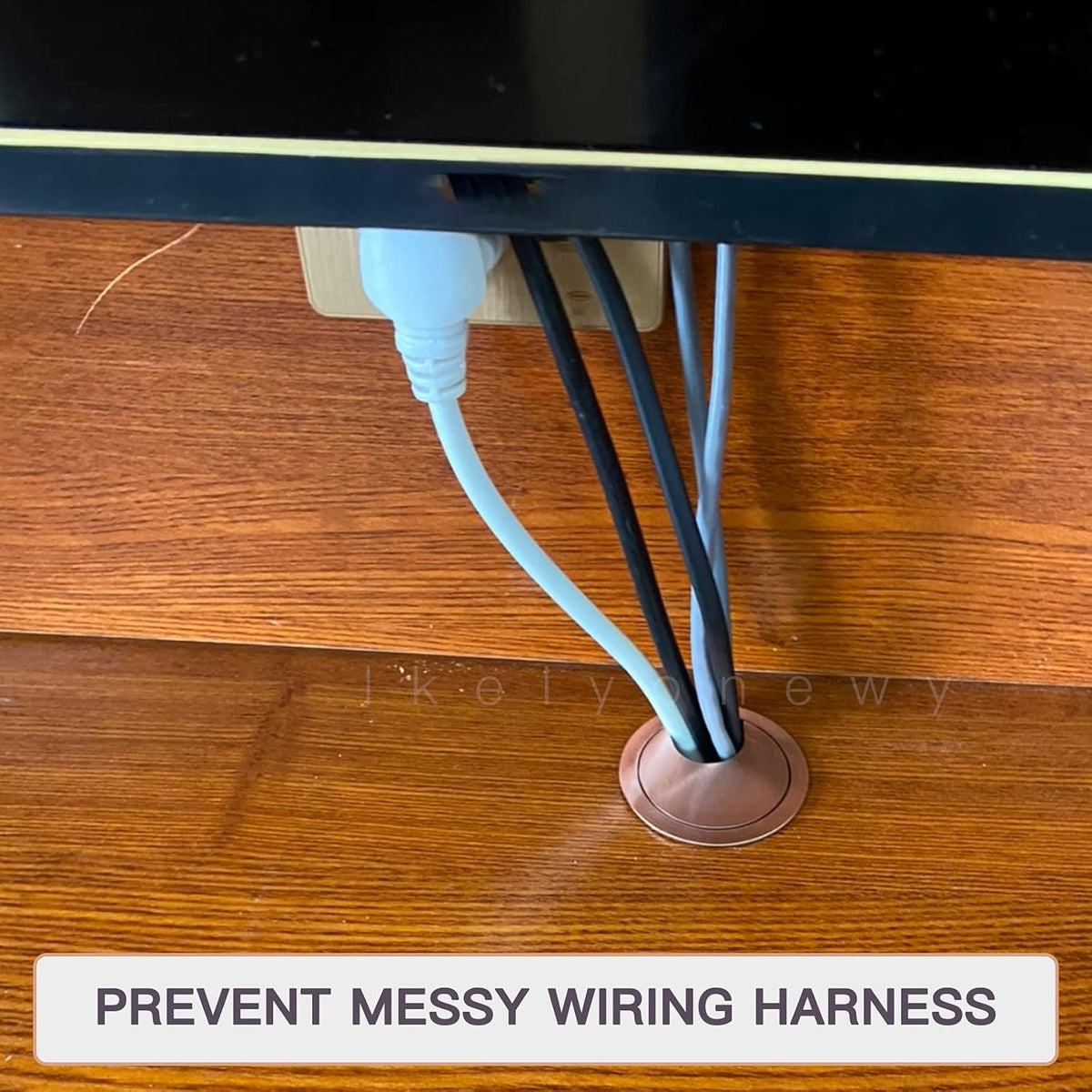 Stylish metal desk grommet cover preventing cable clutter, enhancing workspace organization and aesthetics.