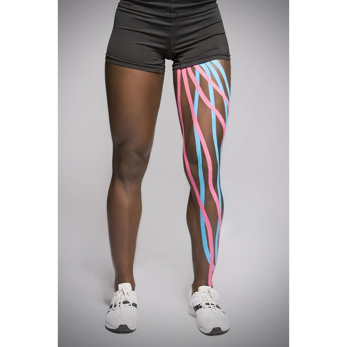 Original Kinesio Tex Classic W/R tape applied to athlete's leg, enhancing muscle support and recovery. Ideal for active individuals.