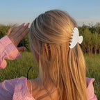 Authentic set of 2 non-slip hair claw clips, ideal for women, featured on a model with flowing hair outdoors.