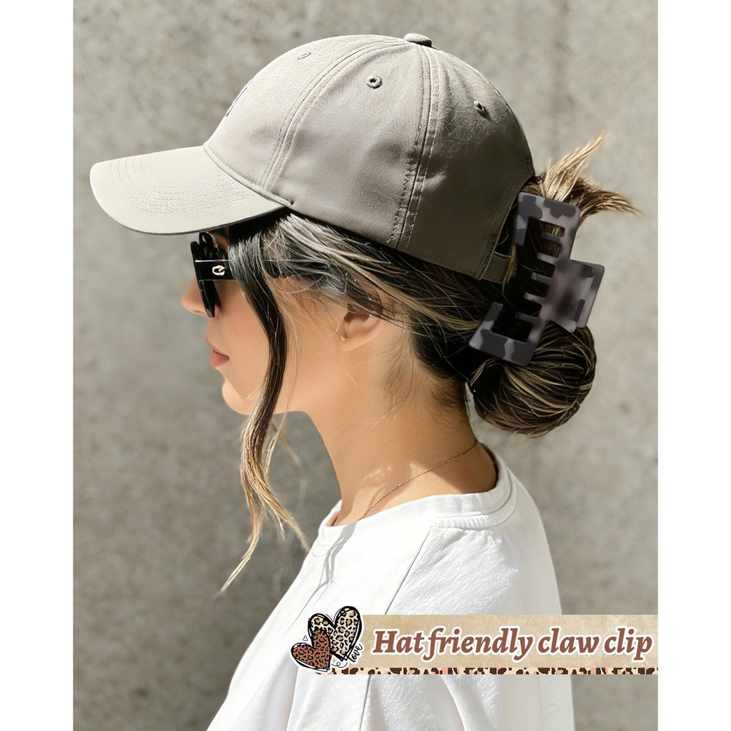A stylish woman in a baseball cap using a hat-friendly claw clip to secure her hair, ensuring comfort and style. Verified by CuratCart.