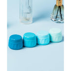Four blue travel containers for toiletries, designed for easy packing. Verified by CuratCart for quality assurance.