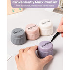 Four stylish, labeled travel containers for toiletries, ideal for organizing shampoo, body wash, and lotion.