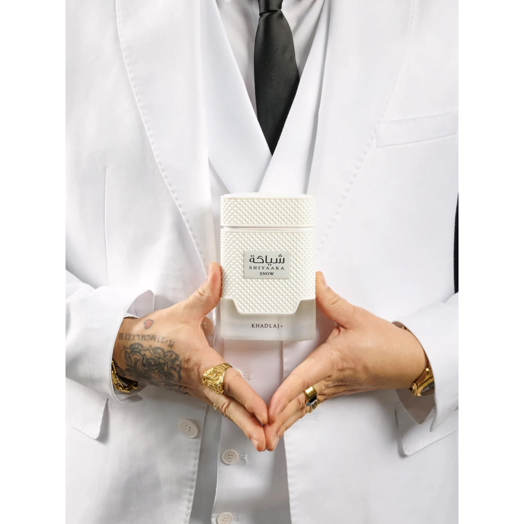 Premium imported Khadlaj Shiyaaka Snow fragrance featuring citrusy and woody notes, elegantly presented in a stylish white bottle.