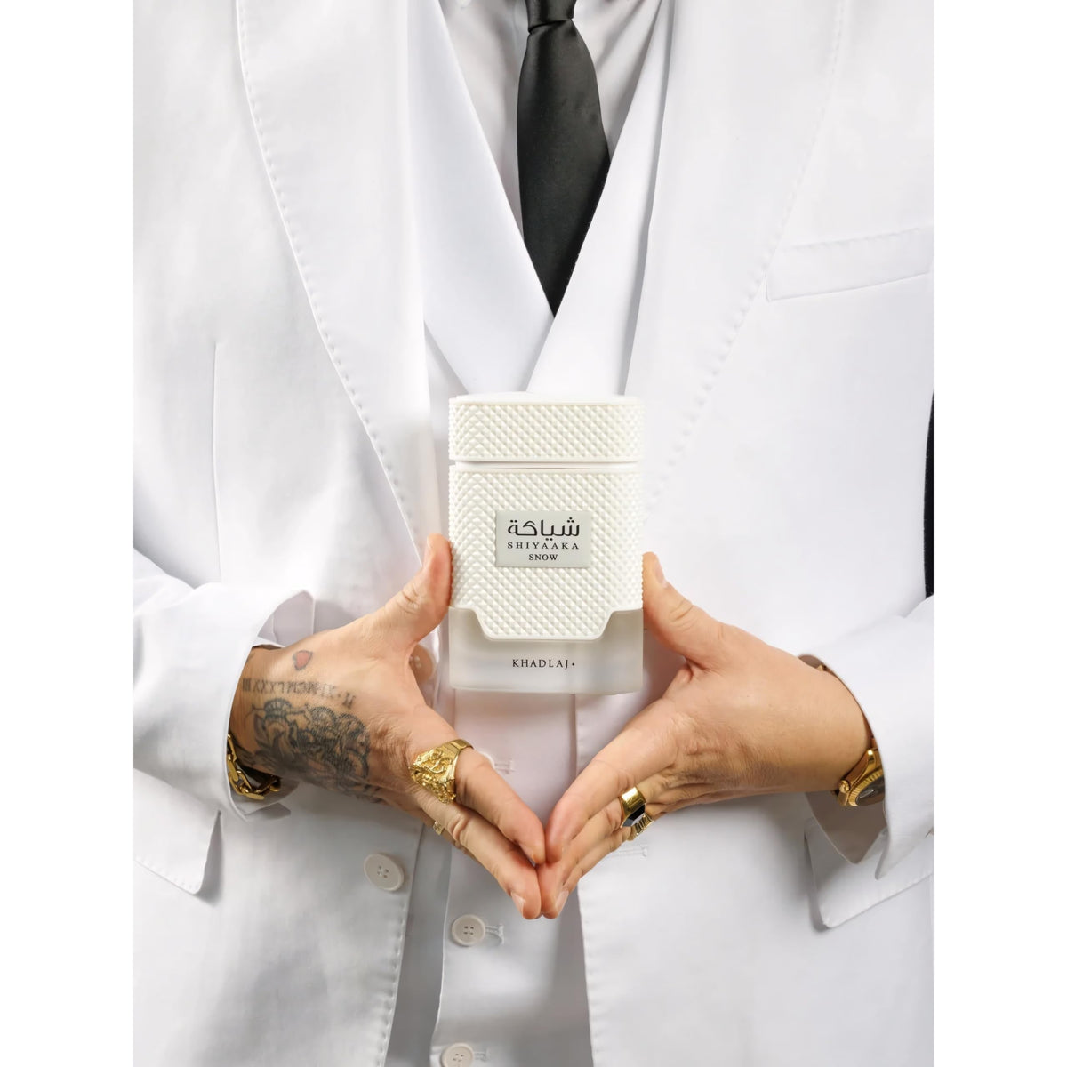 Premium imported Khadlaj Shiyaaka Snow fragrance featuring citrusy and woody notes, elegantly presented in a stylish white bottle.