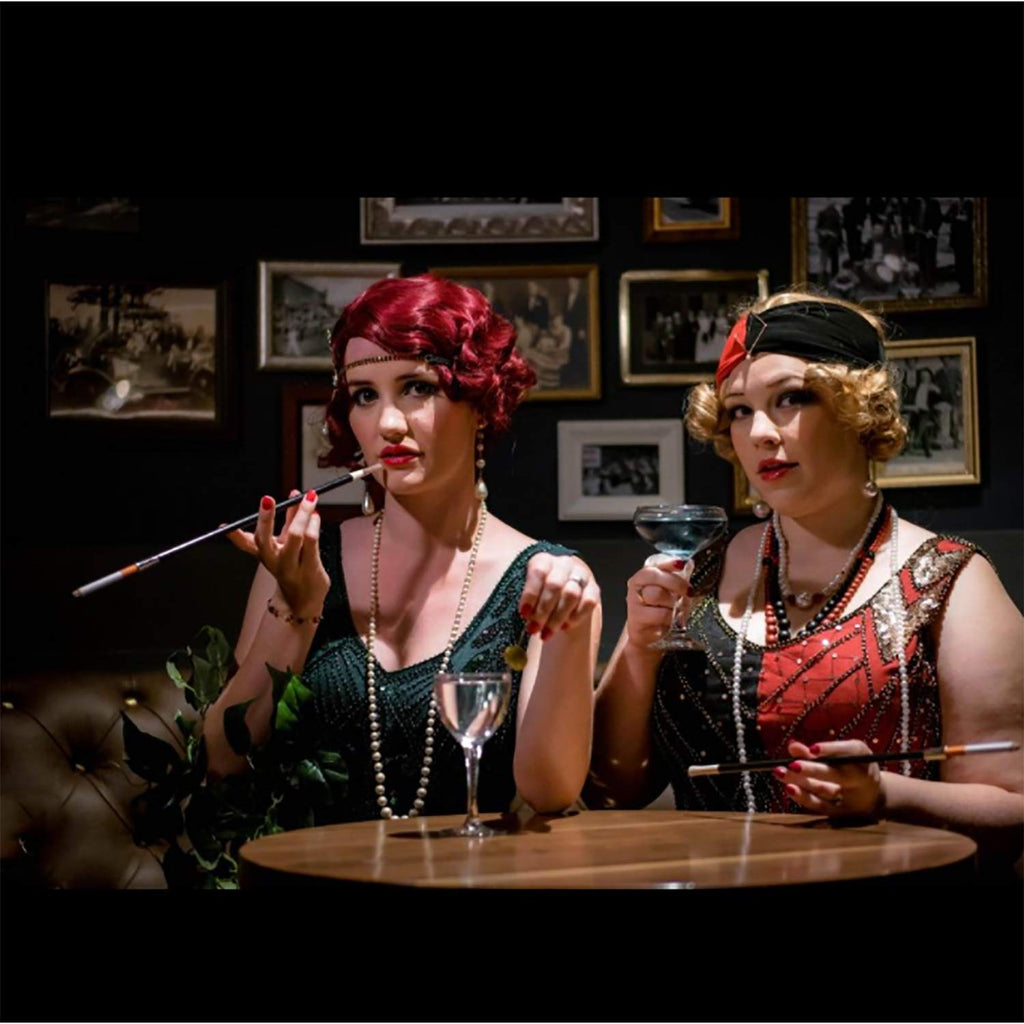Elegant 4E's Novelty Cigarette Holders showcased in a classy vintage bar scene, featuring high-quality finish. Available at Curat Cart.