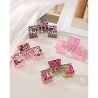 Set of vibrant claw clips with floral and animal prints, designed to complement baseball caps while securing hair.
