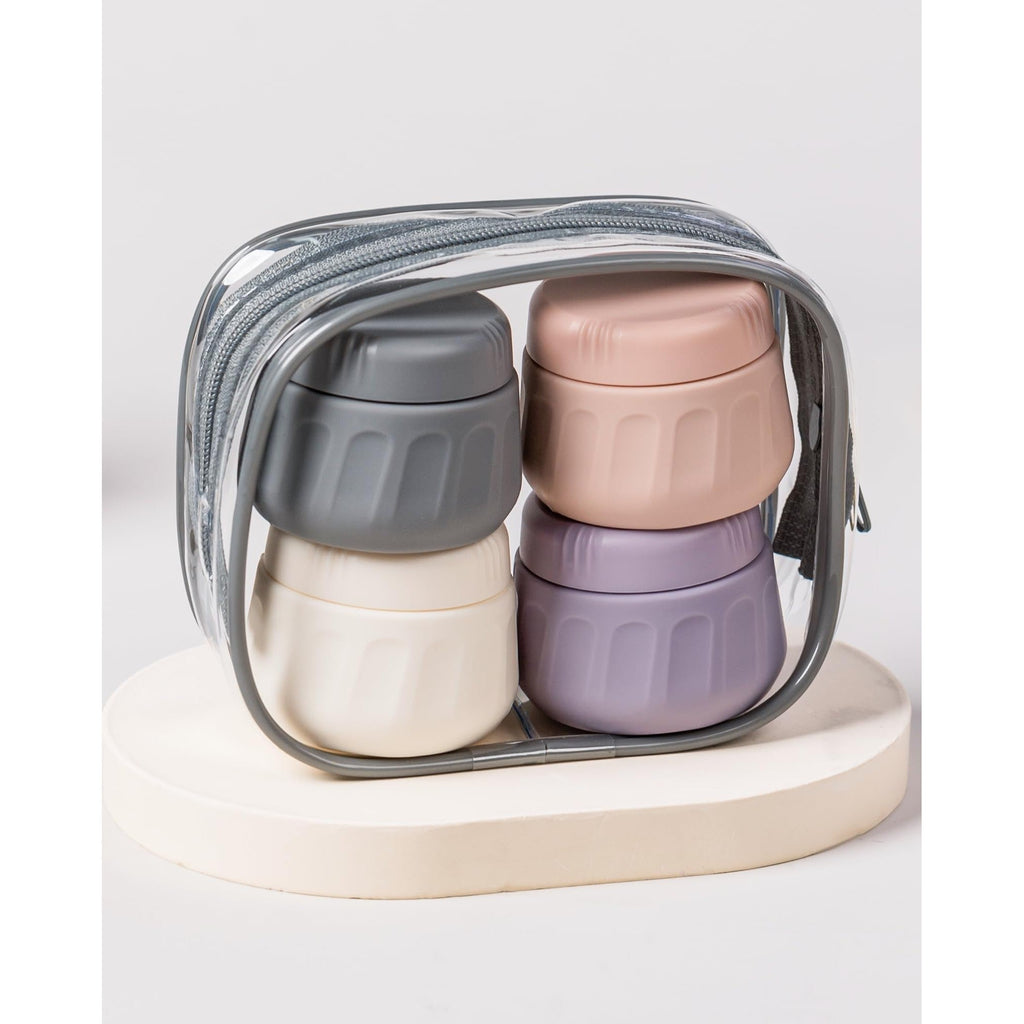 Set of four premium silicone travel containers in pastel colors, conveniently packed in a zippered transparent case.