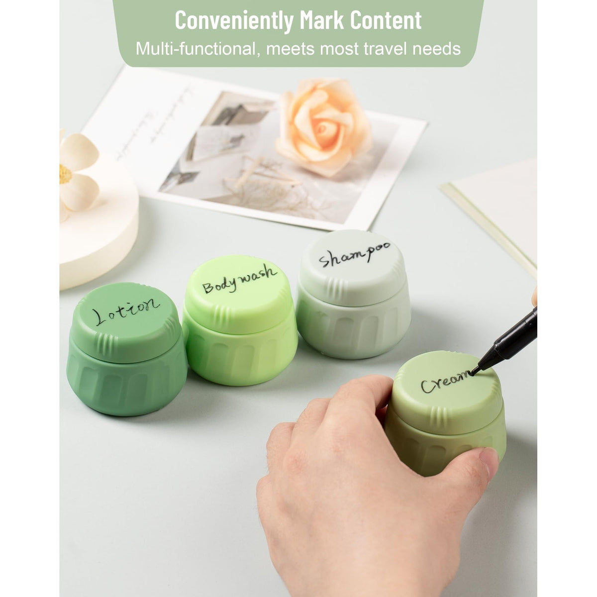 Set of four labeled travel containers for toiletries, showcasing lotion, body wash, shampoo, and cream.