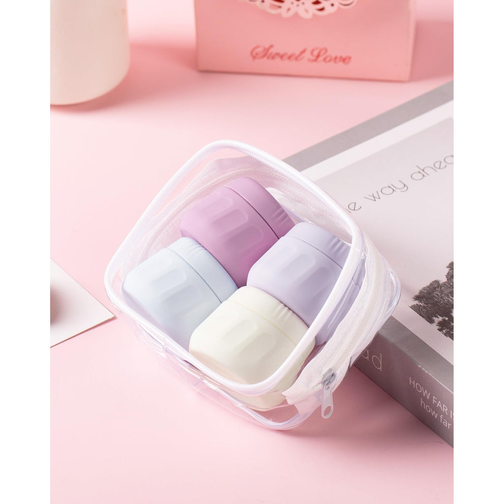 Set of four pastel travel containers in a clear pouch, perfect for toiletries. Verified by CuratCart for quality.