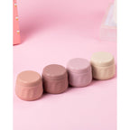 Four pastel-colored travel containers for toiletries, featuring secure lids and a stylish design, perfect for on-the-go use.
