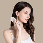 Elegantly designed RHOS folding brush with built-in mirror, perfect for on-the-go touch-ups and hairstyling.