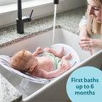 The First Years Sure Comfort Folding Baby Bather - Foldable Baby Bath Seat and Lounger for Home or On the Go - for Sink or Tub Use - Non-Slip Seat - For Up to 15 Lbs