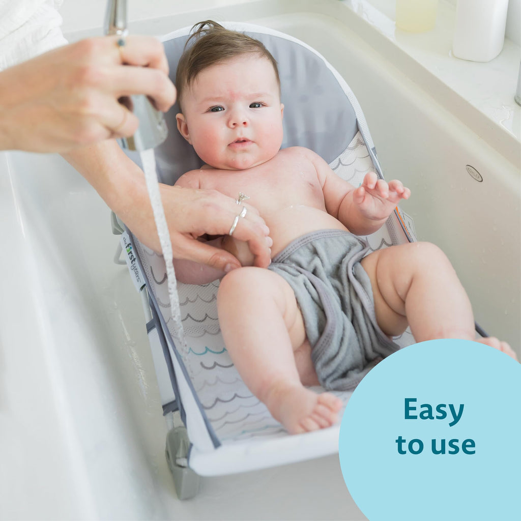 The First Years Sure Comfort Folding Baby Bather - Foldable Baby Bath Seat and Lounger for Home or On the Go - for Sink or Tub Use - Non-Slip Seat - For Up to 15 Lbs