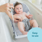 The First Years Sure Comfort Folding Baby Bather - Foldable Baby Bath Seat and Lounger for Home or On the Go - for Sink or Tub Use - Non-Slip Seat - For Up to 15 Lbs