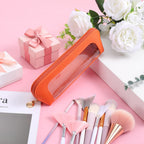 Stylish small clear makeup bag in orange, perfect for organizing cosmetics. Verified by CuratCart for quality assurance.