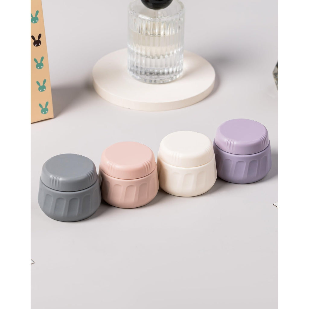 Set of four colorful travel containers for toiletries. Available in India. Order online for convenience!