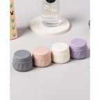 Set of four colorful travel containers for toiletries. Available in India. Order online for convenience!