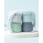 Four stackable travel containers for toiletries in a clear zip bag, ideal for organized packing. Verified by CuratCart.