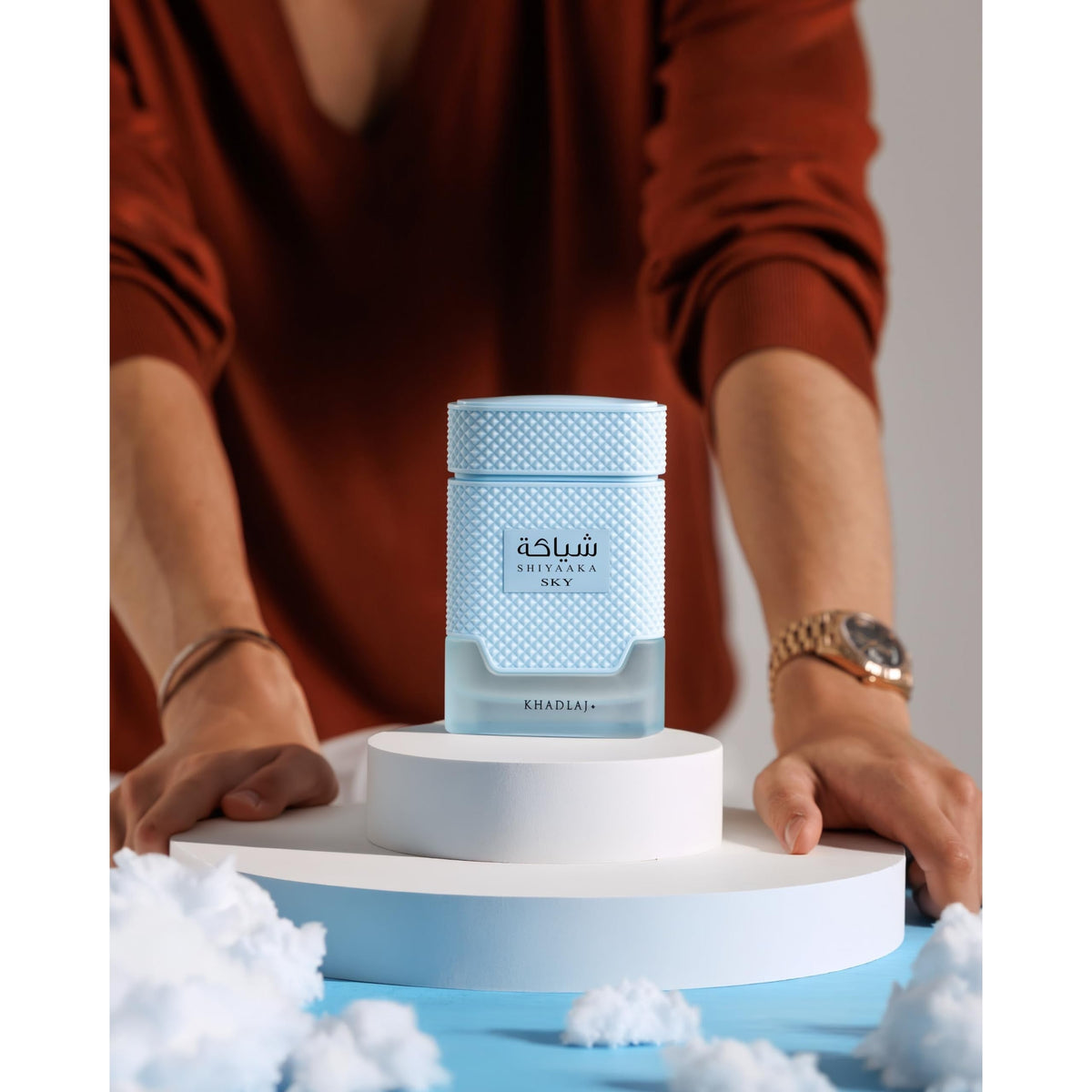 Khadlaj Shiyaaka Snow fragrance, a citrusy and woody scent, showcased on a pedestal, verified by CuratCart.