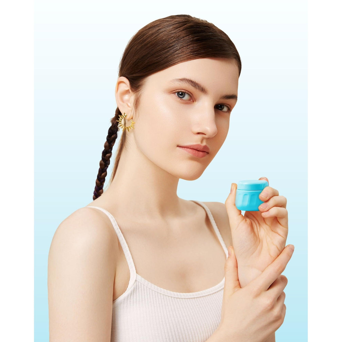 Model holding a blue Mrsdry travel container for toiletries. Verified by CuratCart for quality and trust.