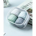Set of four premium imported toiletry containers in soft colors, perfect for travel organization in a clear case.