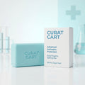 CURAT CART Antiseptic Soap Bar next to its white retail packaging, highlighting a 99.9% clean feel.