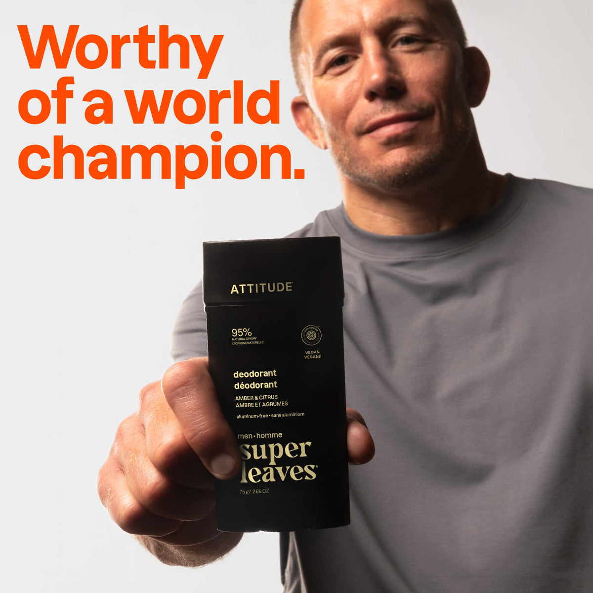 A man holding Attitude Men's Patchouli & Bourbon Deodorant, promoting trust with 'Worthy of a world champion.' Verified by CuratCart.