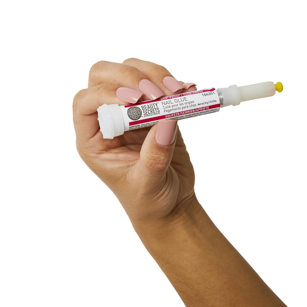 A hand holding Beauty Secrets Drip & Clog Proof Nail Glue. Verified by CuratCart for quality assurance.