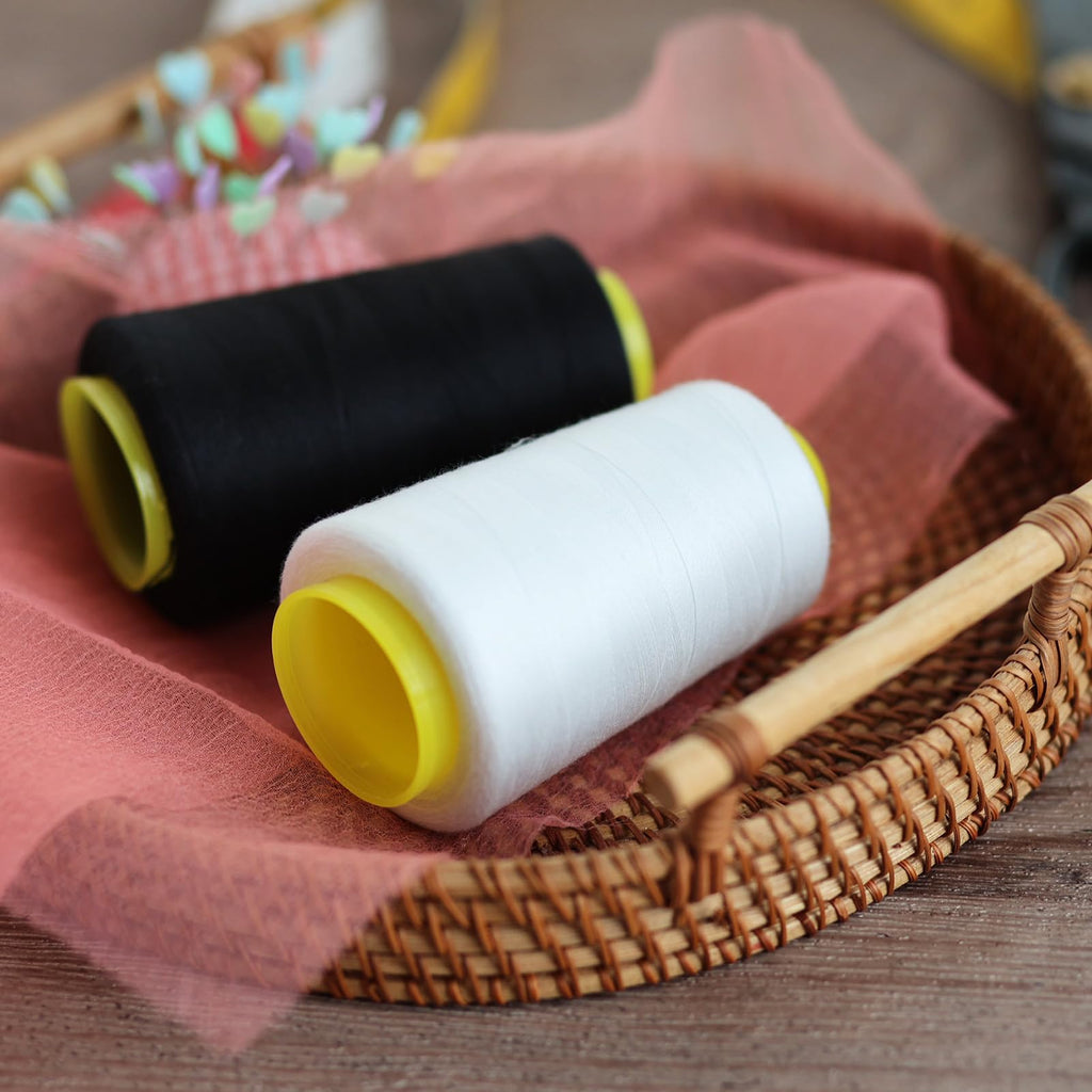 Premium imported black and white sewing thread spools, perfect for your creative projects. Available at Curat Cart.