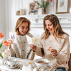 Two women enjoying premium imported blank greeting cards with envelopes at Curat Cart. Perfect for personalized messages.