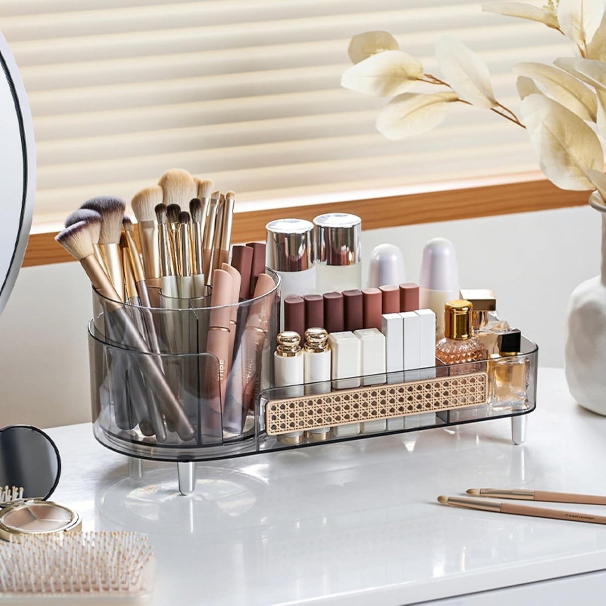 Elegant rotating makeup organizer with multiple compartments, perfect for displaying and organizing beauty products. Ideal for vanity use.