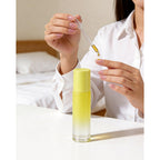 A person using a roller bottle for essential oils, perfect for aromatherapy. Available in packs of 12. Order online today!