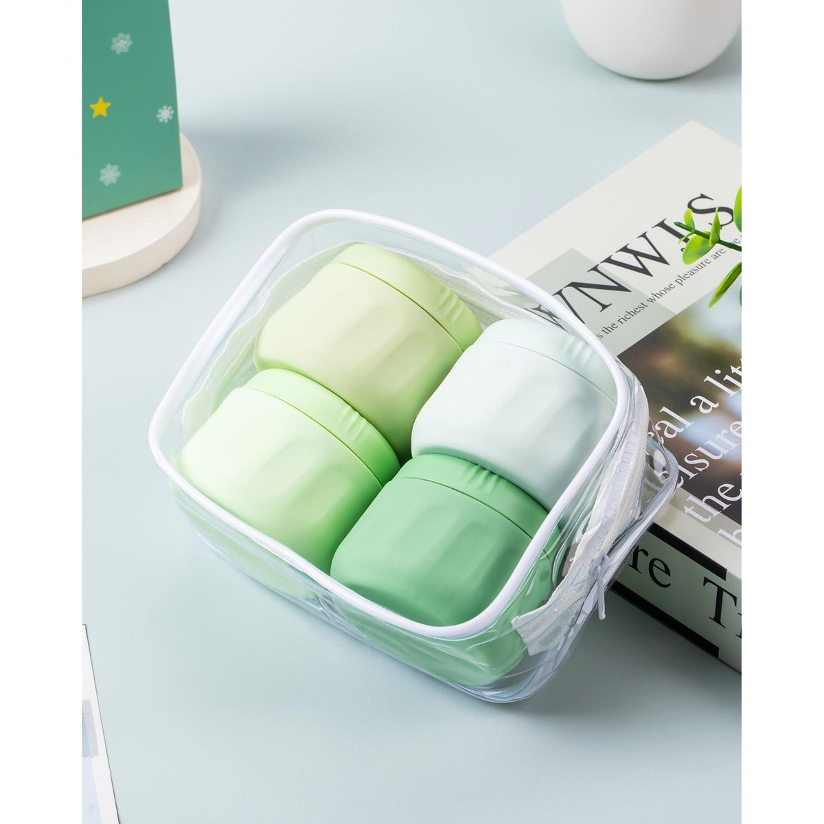 Premium imported travel containers for toiletries, featuring four soft silicone jars in green and white, ideal for travel.