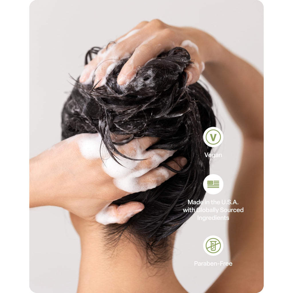 User applying Divi Volumizing Shampoo & Conditioner in the shower. Vegan, paraben-free, and made in the U.S.A.