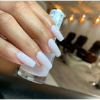 DND Gel Nail Polish Duo in white applied on perfectly manicured nails, showcasing a glossy finish and sleek design.