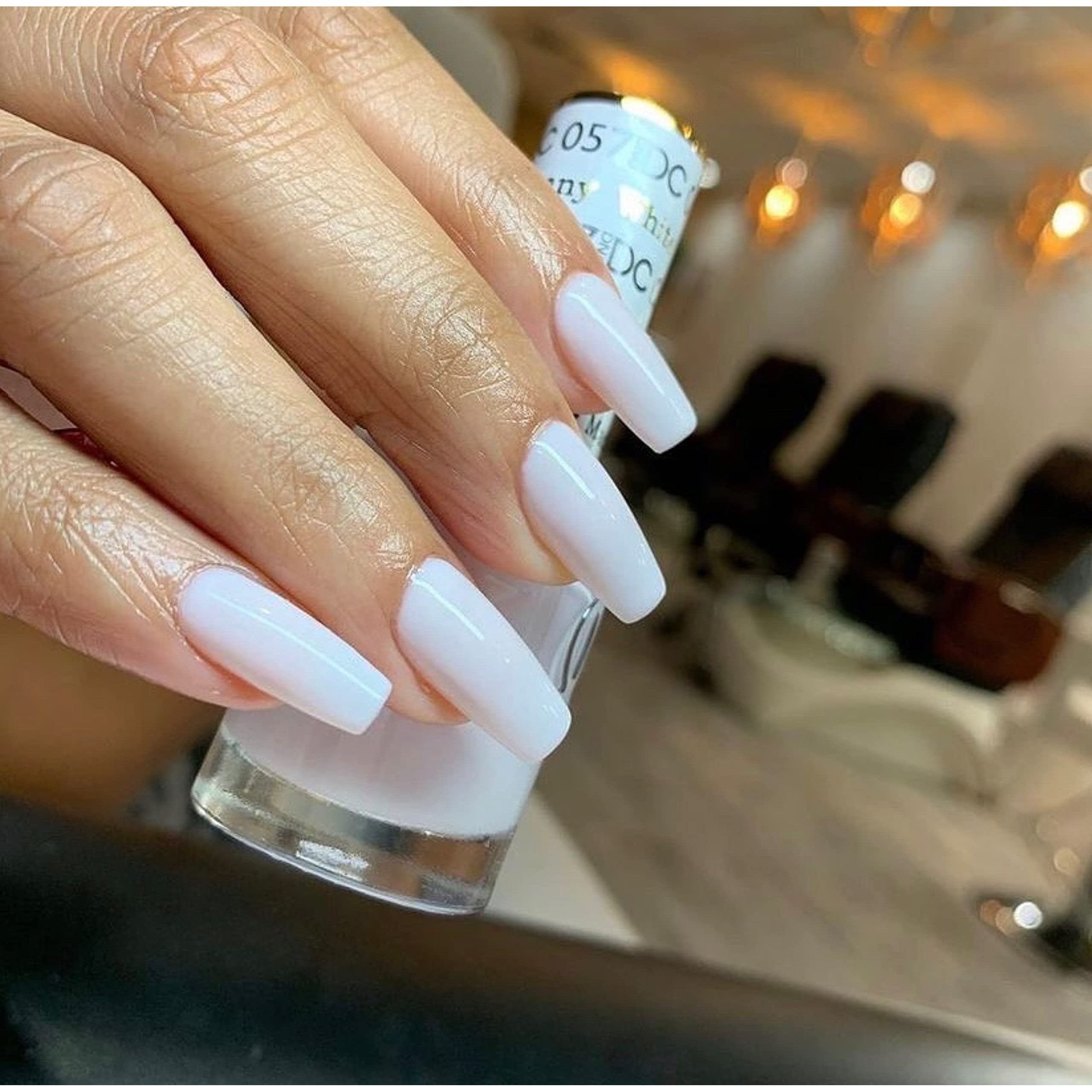 DND Gel Nail Polish Duo in white applied on perfectly manicured nails, showcasing a glossy finish and sleek design.
