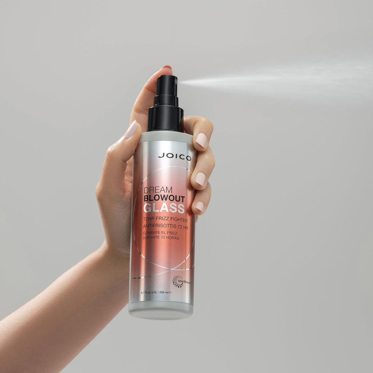 Holding Joico Dream Blowout Glass spray, a 72-hour frizz fighter. 100% genuine product for smooth, shiny hair.