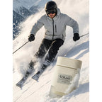 A man skis down a snowy mountain, showcasing Khadlaj Shiyaaka Snow fragrance. Available in India, order online today!