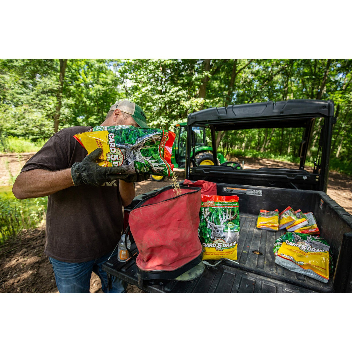 Evolved Harvest Food Plot Seed being poured from bag into container. Specially curated by Curat Cart for premium quality gardening.