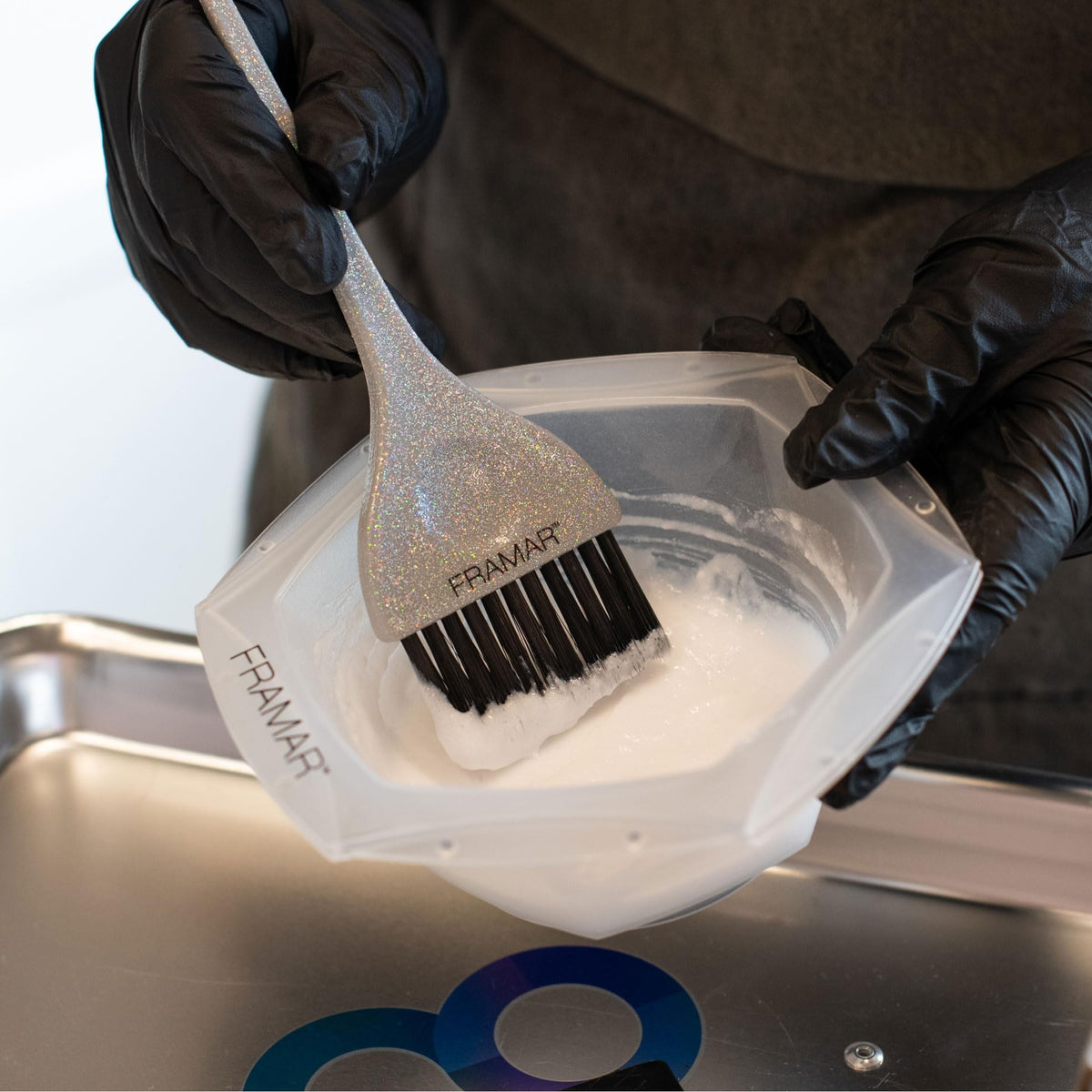 Authentic Framar Family Hair Color Brush Set with shimmering brush applying color from a bowl, ideal for at-home dyeing.