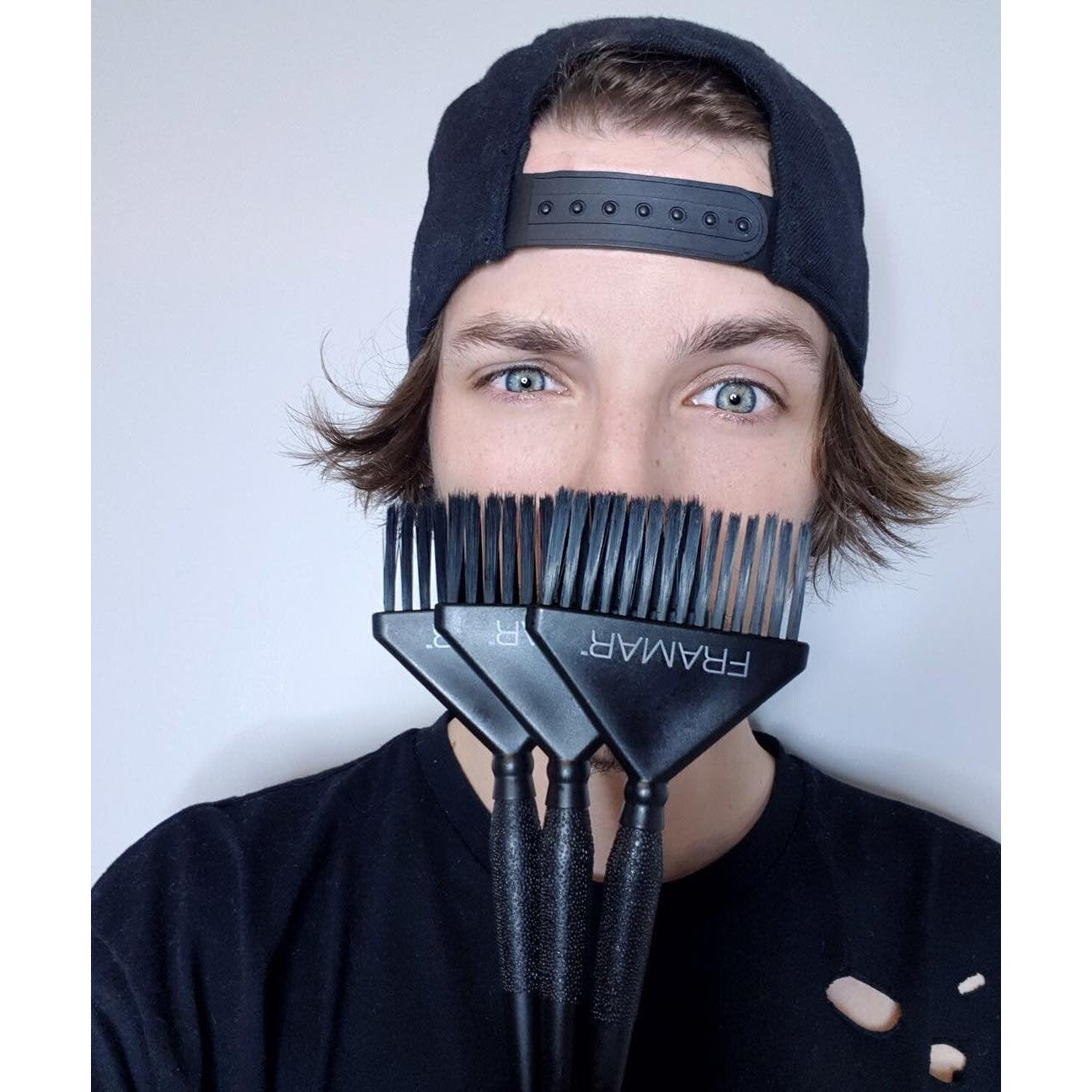 Framar Family Hair Color Brush Set features durable brushes held by an enthusiastic model, perfect for vivid at-home coloring.