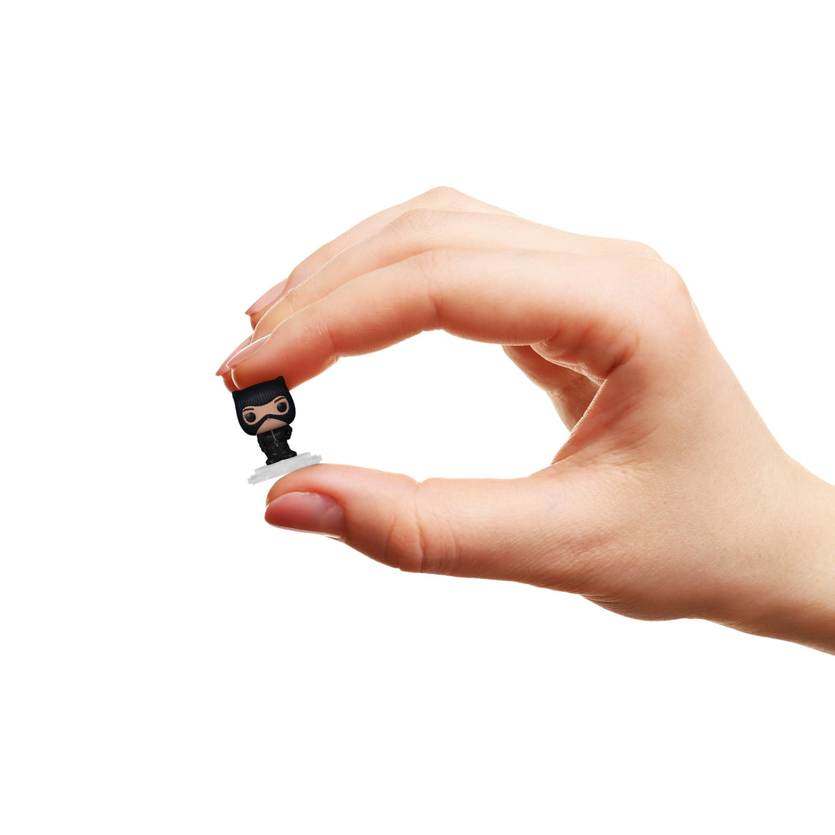 A person holds a Funko Bitty POP! Batman figure, part of the 4 Pack. Available online for order now!