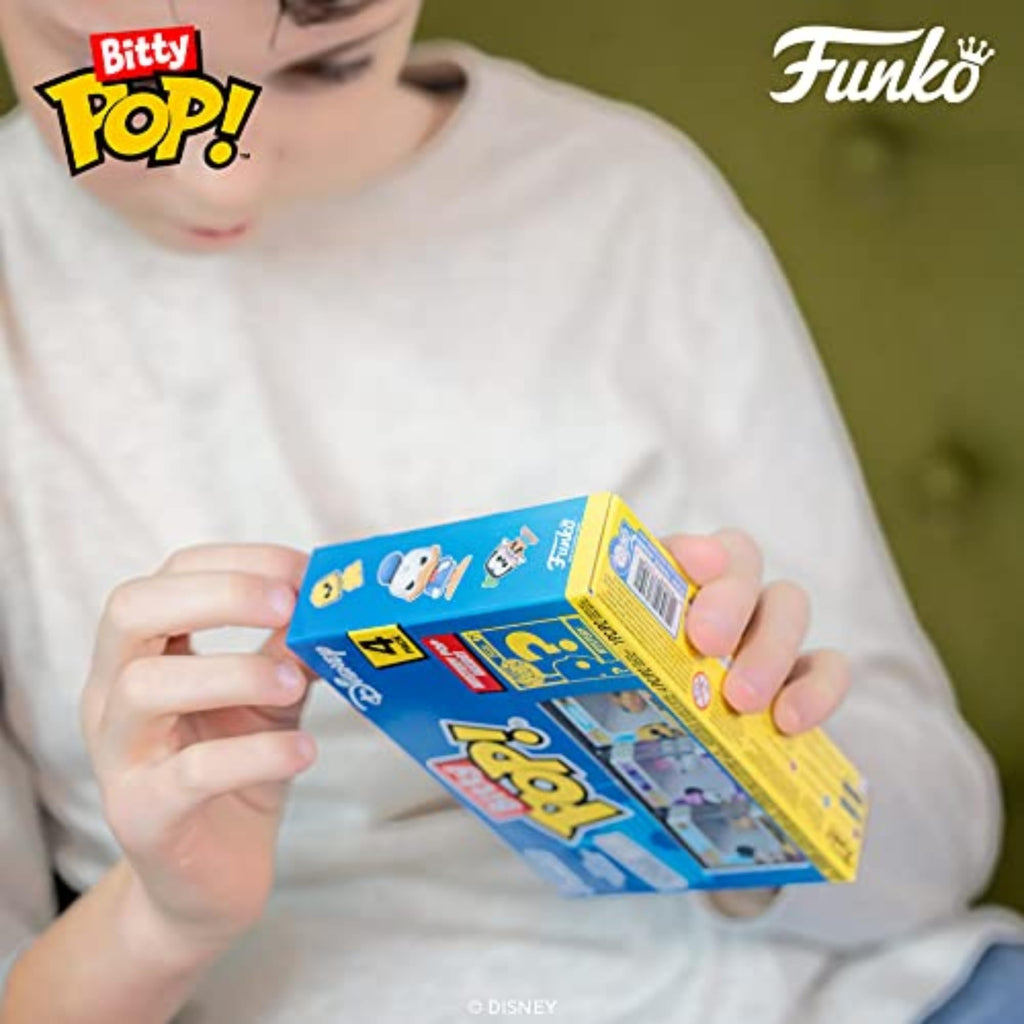 Child holding the Funko Bitty POP! 4 Pack featuring Disney characters, with bright packaging. Verified by CuratCart.