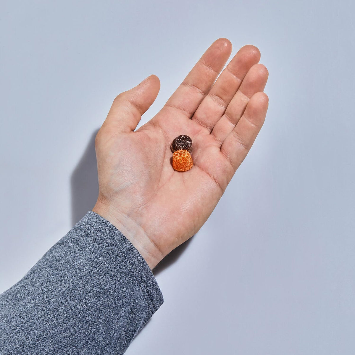 Premium imported GNC Mega Men Multivitamin gummies in hand, a global favorite for daily nutrition.