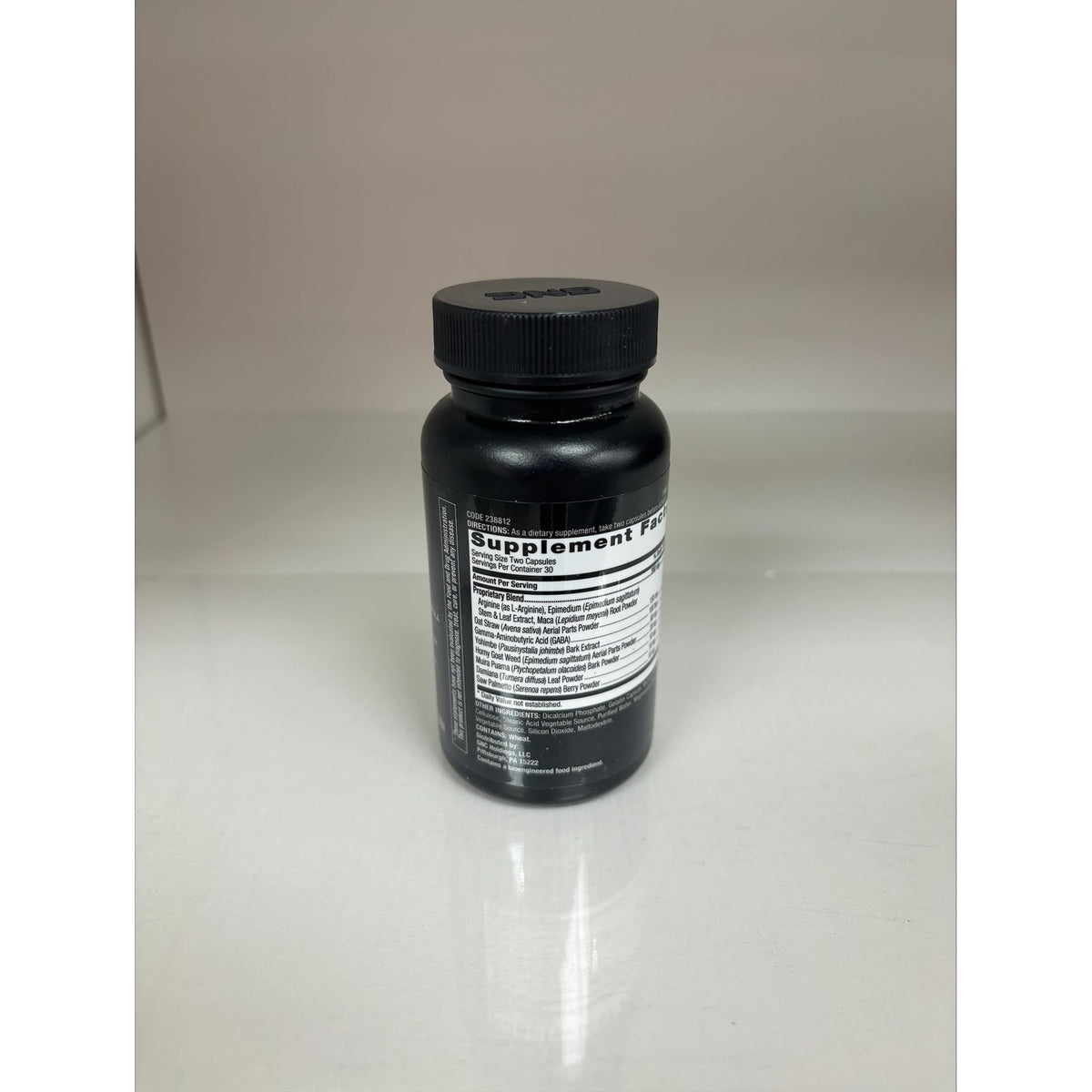 GNC Men's Staminol in a sleek black bottle, featuring a clear label detailing its supplement information.